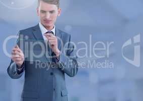 Businessman holding glass screen in large blue space