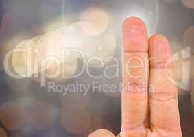 Two fingers with sparkling light bokeh background
