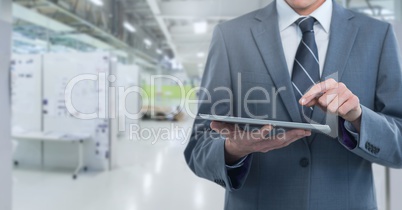 Businessman holding tablet in long room space