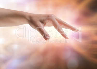 Hand stretched fingers with sparkling light bokeh background