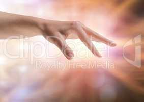 Hand stretched fingers with sparkling light bokeh background