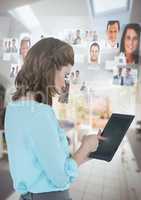 Businesswoman holding tablet with people's profile pictures at home
