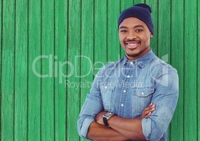 hipster with hat and hand folded with green wood background