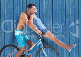 couple in bicycle with blue wood background