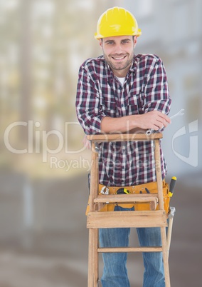 Construction Worker on ladder in front of construction site