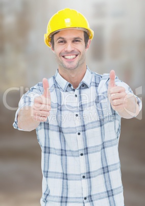 Construction Worker with thumbs up in front of construction site