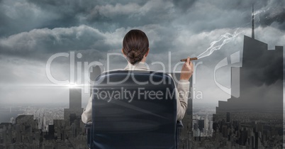 Businesswoman seated in a chair smoking and watching the town