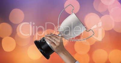Business hand holding trophy against abstract background