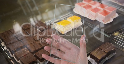 Hand photographing brownies through transparent device