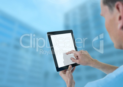 Doctor holding tablet with tall blue buildings