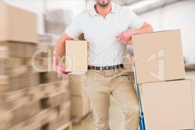 delivery man in warehouse holding package