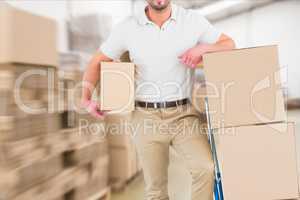 delivery man in warehouse holding package
