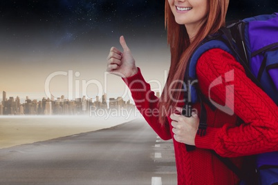 Traveler with thumbs up on a road