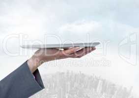 Businesswoman holding tablet over bright round city