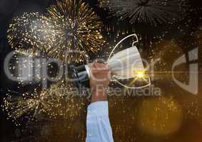 Business hand with trophy in a gold fireworks and lights