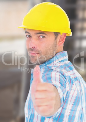 Construction Worker with thumbs up in front of construction site