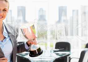 businesswoman hand with trophy in the meeting room