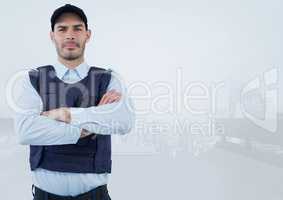 Security man arms folded  on bright background in front of city
