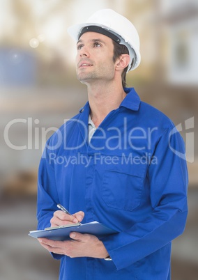 Construction Worker with pen chart in front of construction site