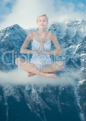 Woman doing yoga in front of snow-covered mountains