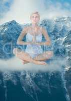 Woman doing yoga in front of snow-covered mountains