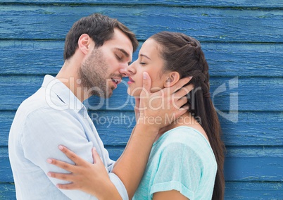 couple kiss with blue wood background