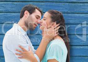couple kiss with blue wood background
