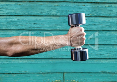 fitness: hand with wight with light blue wood background