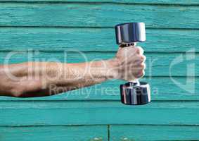 fitness: hand with wight with light blue wood background