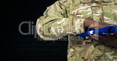 soldier with USA flag in the hands, dark background