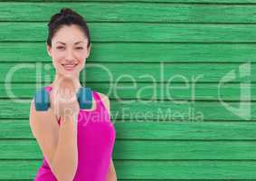 fitness woman with weight  with green wood background