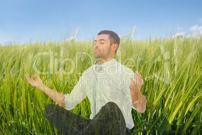 Man doing yoga in field of green sproutings