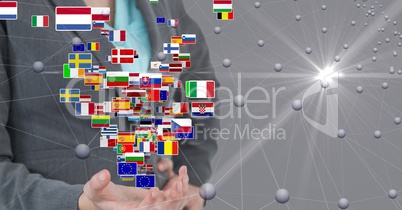 Digital composite image of businesswoman standing with flags and connecting dots