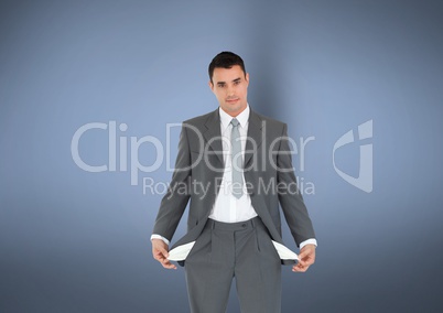 Portrait of businessman with empty pockets standing against gray background representing no money