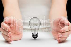 Light bulb between two hands