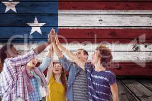 students clapping their hands against wooden american flag background