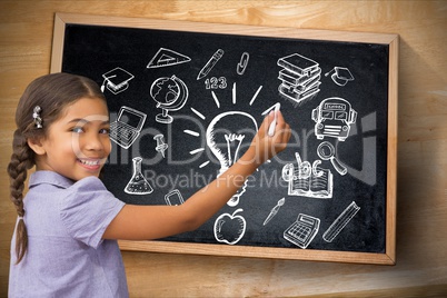 Student drawing graphics against board school background