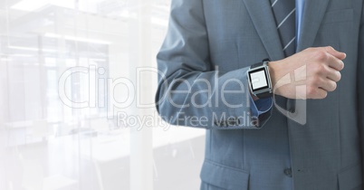 Businessman with watch in bright room