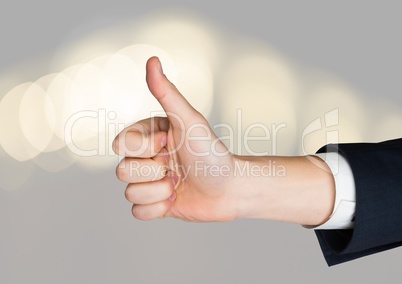 Hand Thumbs up with sparkling light bokeh background