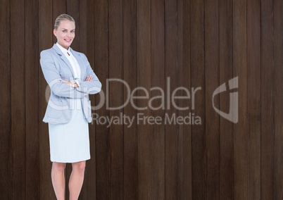 Business woman standing with arm crossed against wooden background