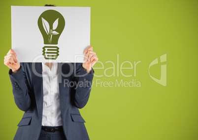 Business woman with card over face and green lightbulb graphic against green background