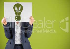 Business woman with card over face and green lightbulb graphic against green background