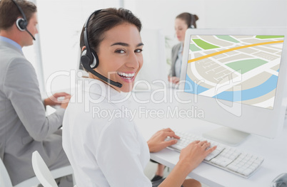models wearing Head set sitting in front of computer against office background