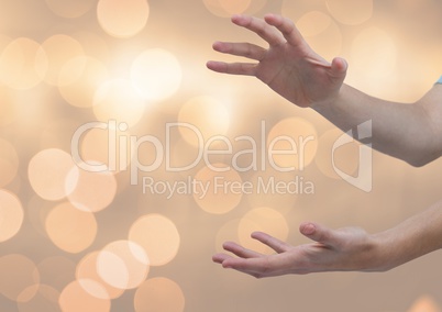 Hands open holding invisible shape with sparkling light bokeh background