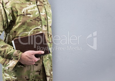 soldier with books, concrete wall