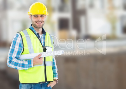 Architect with blueprints on building site