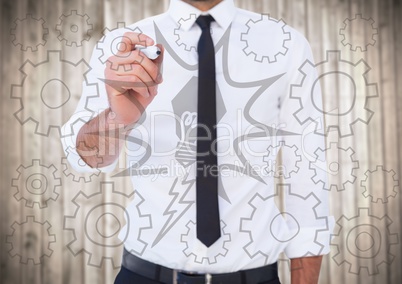 Business man mid section writing lightbulb and cog  doodles against blurry wood panel