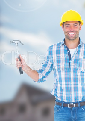 Construction Worker with hammer in front of construction site