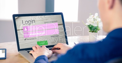 Businessman trying to login while working on laptop at office