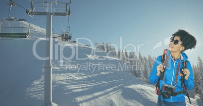 Hiker looking at ski lift while standing on snow covered mountain